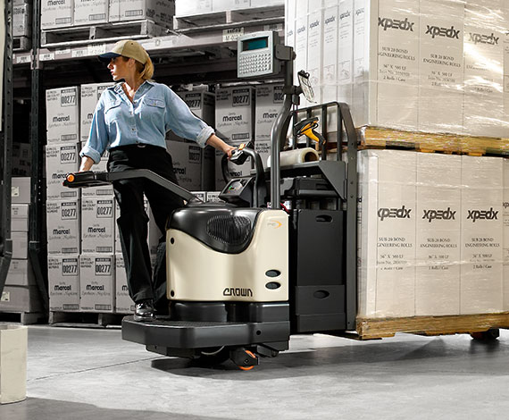 Operator moves loaded pallets using PE series and walkie rider pallet jack with double length forks