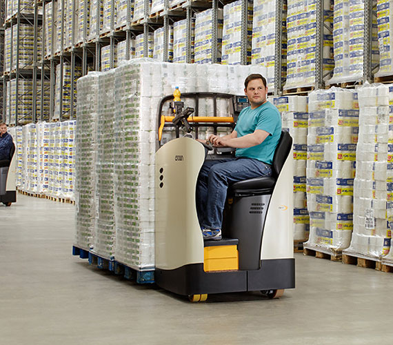 Operator moving a load with the RT ride-on pallet truck